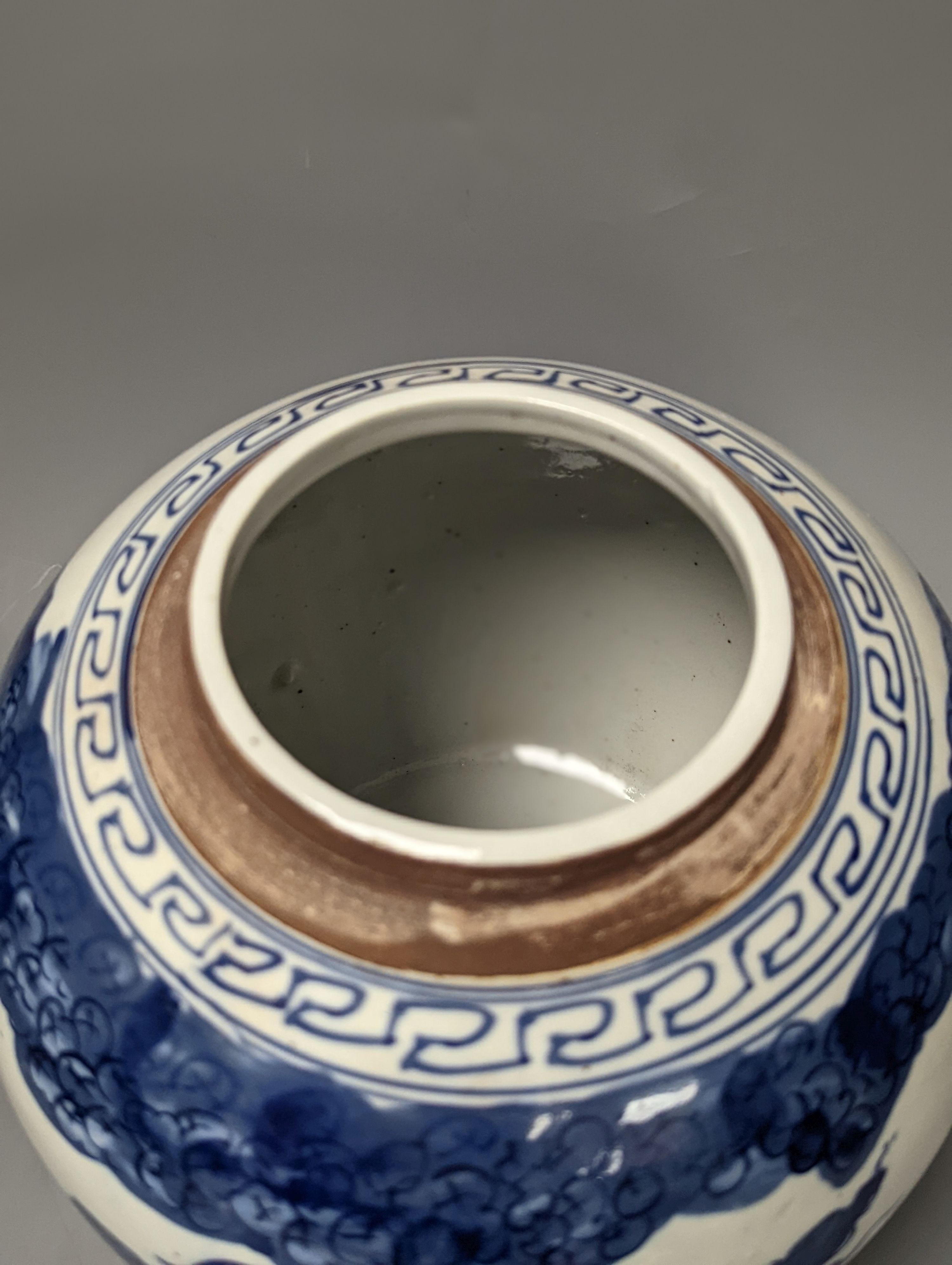 A Chinese blue and white jar and cover, 25 cm high and a celadon glazed lamp